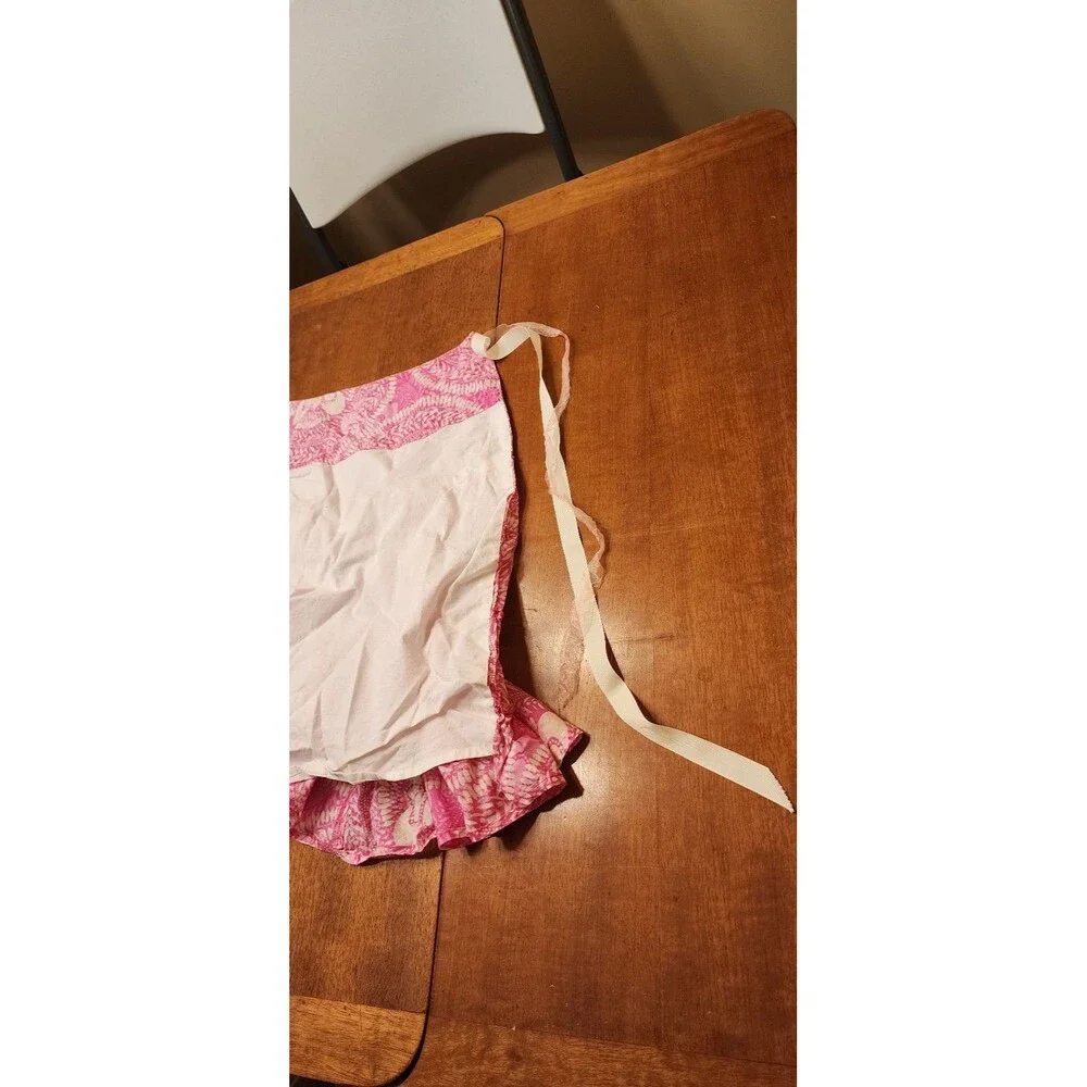 Vintage pink and white ruffled apron read and see
